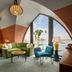 The July - Boat & Co in Amsterdam lounge with arched waterfront window and green sofa