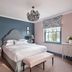 The Alfriston, Polegate: stylish guest room with king bed, bench, patterned drapes and chandelier