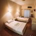 Hotel King Pyrros, Ioánnina: simple twin bedroom with two single beds, wall art and window with curtains