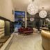 Post Hotel - Tradition & Lifestyle Adults Only lobby in San Candido with gold seating and hanging globe lights
