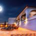 Villa Welwitshia in Praia do Carvoeiro, moonlit pool terrace with lounge chairs beside the hotel