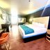 Casa Blanca Hotel - Orange guest room with king bed, desk, chair, and window light in Orange