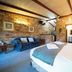 Blickinstal Holiday Retreat Tanunda guest room with brick walls, bed, and sofa