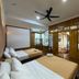 Anjung Pantai Seberang, Kuala Terengganu: twin beds in a wood-paneled hotel room with ceiling fan