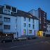 Zollamt Design Hotel in Kaiserslautern, street view of the hotel exterior at dusk