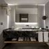 The Wings Hotels Karakoy in Istanbul bathroom with double sink vanity, large mirror and black marble countertop.