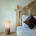 Gili Amor Boutique Resort in Pemenang, carved wooden headboard with bedside lamp and neatly made bed