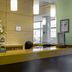 Hotel La Boroña in Gijón reception desk with wood-paneled wall and pendant lights