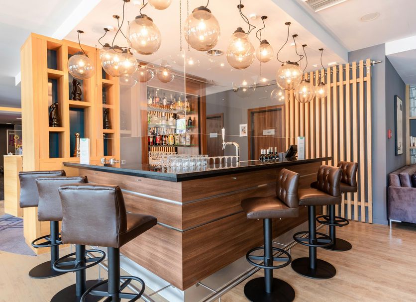 Premier Inn Stuttgart Airport bar lounge with high stools and hanging globe lights in Leinfelden-Echterdingen