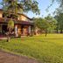 Hotel Villa Cantabria in Mascota with a large lawn, shaded patio, and hammocks beside the building