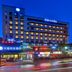 Hanting Express Hangzhou Cuiyuan Branch in Hangzhou exterior at night with lit windows and street-level shops