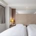 Green World Mai - Nanjing hotel room in Taipei City with twin beds, bedside lamps and headboard