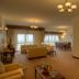 Siji Hotel Apartments in Fujairah living room with sofas, dining table, and large windows