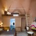 Le Club Boutique Hotel Lecce room with loft bed, ladder, desk, and bathroom doorway