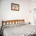 Trafalgar Lodge Nelson guest room with double bed, wall-mounted TV, and open bathroom doorway