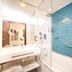 Vip Executive Picoas Hotel Lisbon bathroom with glass shower and blue tile wall