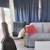 Il Camaleonte dal 2005 in Bracciano: compact room with sofa, chairs, desk, and guitar case