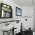 Halez Sparsa Thiruvannamalai bathroom with sink, toilet, shower, and tiled walls in Tiruvannamalai