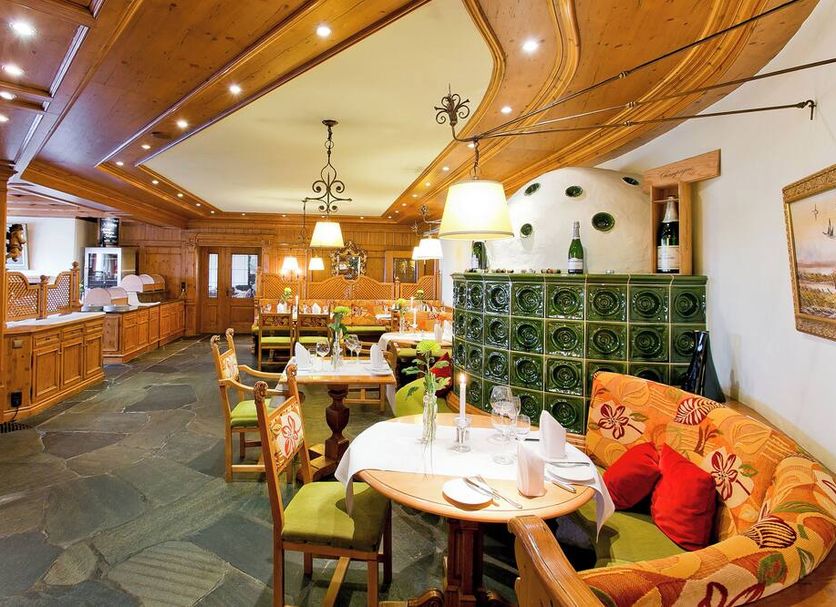 Hotel Reiterhof in Wirsberg dining room with curved wood ceiling, tables, and cozy seating