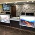 Super 8 by Wyndham Asheville/Biltmore lobby front desk with stone accent wall and herringbone tile floor