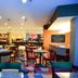 Fairfield Inn & Suites by Marriott Houston North/Spring breakfast area with colorful carpet and tables