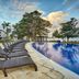 Hideaway at Royalton Negril poolside loungers by an infinity pool with ocean views in Negril