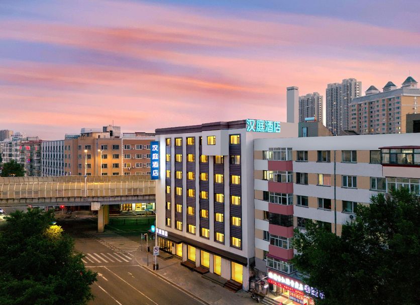 Hanting Hotel Harbin Train Station Branch in Harbin exterior at sunset with city skyline