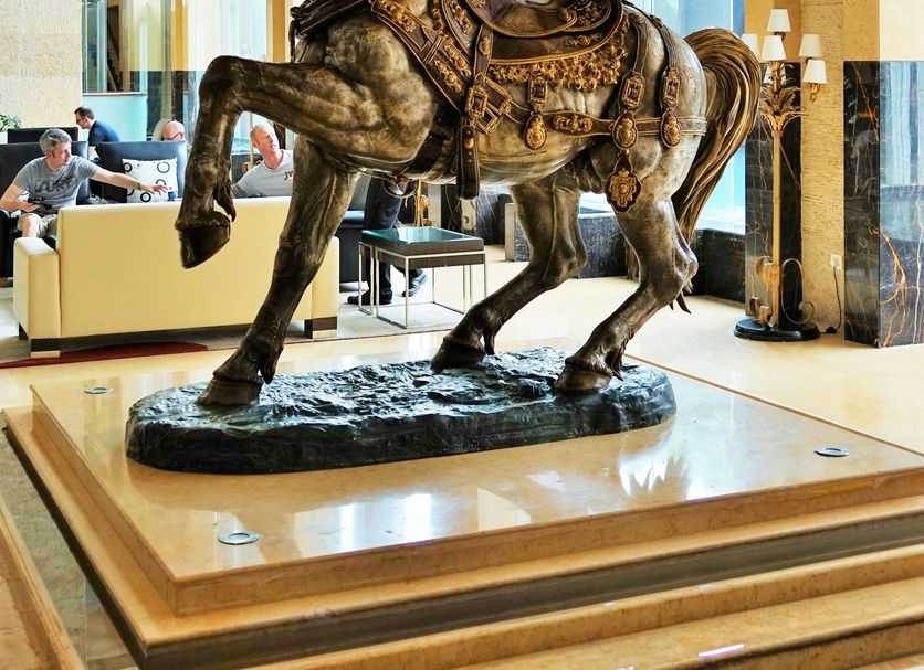 Taj Chandigarh lobby with a large bronze horse sculpture on a raised pedestal