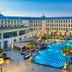 Kempinski Palace Cairo courtyard with checkered pool, palm trees, and grand hotel facade