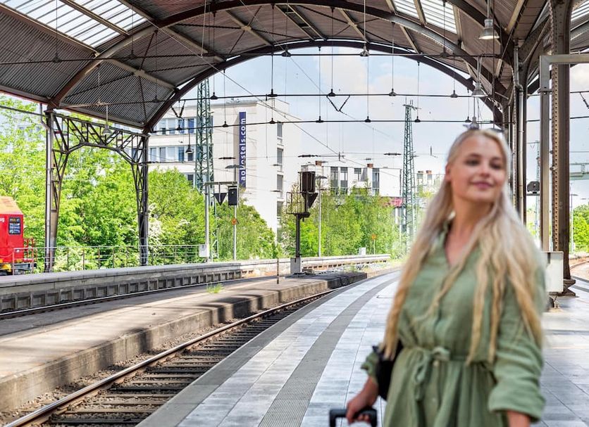 a&o Aachen Hauptbahnhof in Aachen near a train platform under a covered station canopy