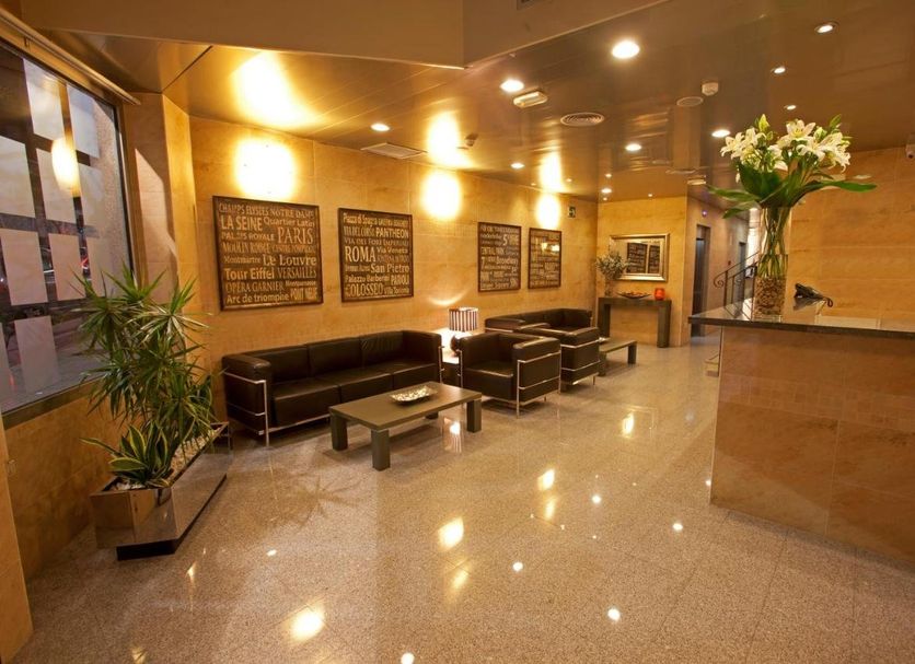 La City Estación Alicante lobby with reception desk, seating area, and polished tile floor