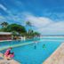 Blu Hotel by Tamaca in Santa Marta, beachfront pool with ocean view and guests relaxing by the water