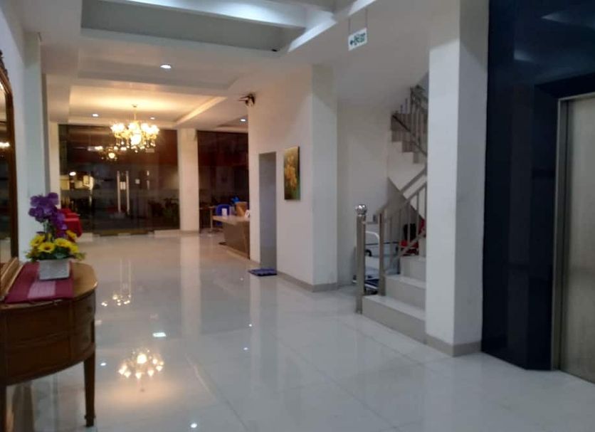 Kanasha Islami hotel lobby in Medan with glossy tile floor, chandelier, staircase and elevator