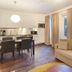 Spa Hotel Peurunka in Laukaa: modern suite with kitchenette, dining table, beige sofa, and large windows