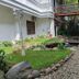 Narita Hotel Tulungagung in Tulungagung courtyard with landscaped garden, rocks, and walkway