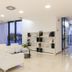 Esperia Palace Hotel & Resort Spa lobby with white seating, bookshelves, and floor-to-ceiling windows in Zafferana Etnea