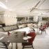 The Byke Suraj Plaza, Thane: modern hotel restaurant with white marble floors and red-accent seating