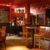 Great Western Hotel Aberdeen bar lounge in Aberdeen with wooden tables, stools and colorful wall art
