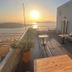 Theoxenia Caldera Hotel in Thera rooftop terrace with sunset sea and caldera views