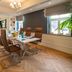 Meeting room at Hilton Frankfurt Gravenbruch in Neu Isenburg with glass table, brown chairs, and herringbone wood floor