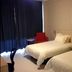 Jinjiang Inn (Huizhou Dadao Hefei) guest room in Hefei with two twin beds, chair, and dark curtains