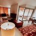 Plaza Inn Week Inn in Campos do Jordão living room with sofa, TV and balcony view