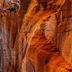Zion Ponderosa Ranch Resort in Mount Carmel with a person rappelling down a red rock canyon wall
