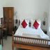 Nalla Eco Beach Resort, Pondicherry: simple guest room with wooden bed, desk, chairs and wardrobe