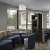 Courtyard by Marriott Greensboro Airport lobby seating area with booths, tables and hanging lights in Greensboro