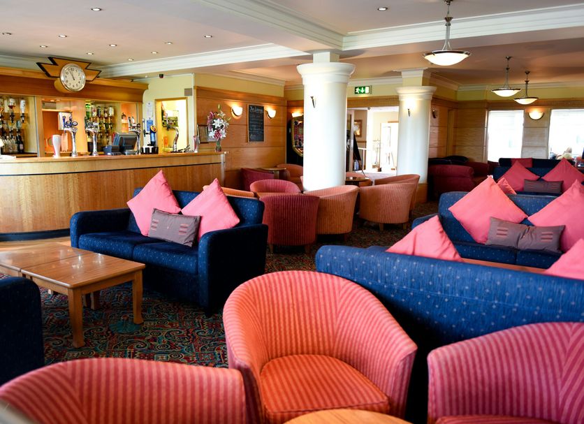 The Riviera Hotel & Apartments - Alum Chine lounge bar in Bournemouth with sofas, armchairs and reception desk