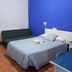 The Dreamers&Co Córdoba guest room with bed, daybed and bright blue accent wall