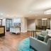 Homewood Suites by Hilton Bonita Springs Naples North lobby with front desk, seating area and small market