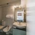 Hotel Alfiero bathroom with toilet, bidet, sink and mirror in Porto Santo Stefano