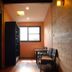 Baan Hanibah, Chiang Mai guest room with wood-paneled walls, window, and seating area